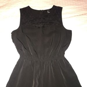 Black romper with lace detail and pockets